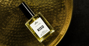 The Motley Kiso Fragrance in a glass bottle and a black pump cap rests on a gold platter.
