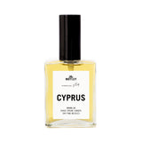 The Motley Cyprus Fragrance in a glass bottle with gold liquid and a black pump cap against a white background