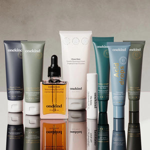 Seven Onekind Products stand against a pale brown background.