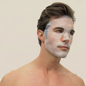 A man has a translucent Port Products Intense Recovery Treatment Mask on his face.