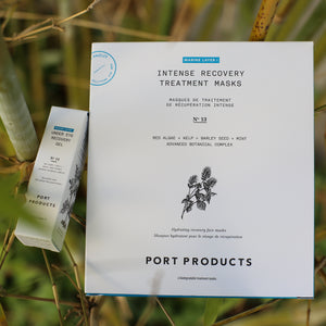 Port Products 4-pack of Intense Recovery Treatment Masks in a white carton and Under Eye Recovery Gel in a white carton rest on the branches of a plant.