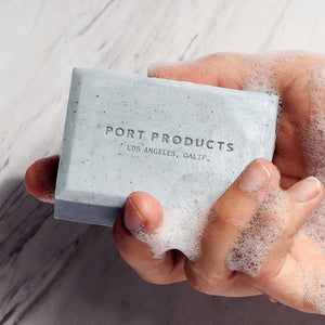 Gray Sand bar soap in man's hand with soap suds