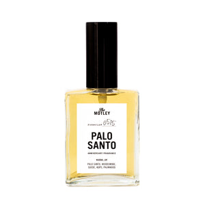The Motley Palo Santo Fragrance in a glass bottle with gold liquid and a black pump cap against a white background.